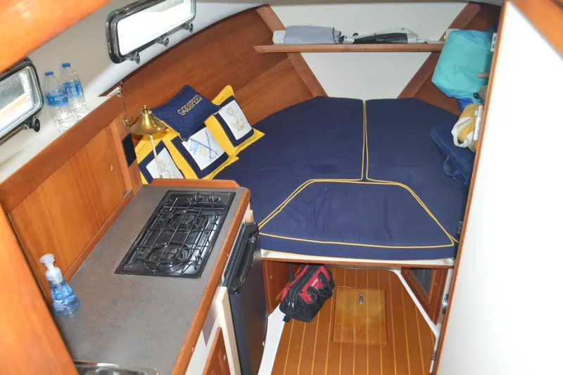 Slide: The Image of Cozy cabin interior of 2003 Legacy 28 Express boat with bed and kitchenette. - 7