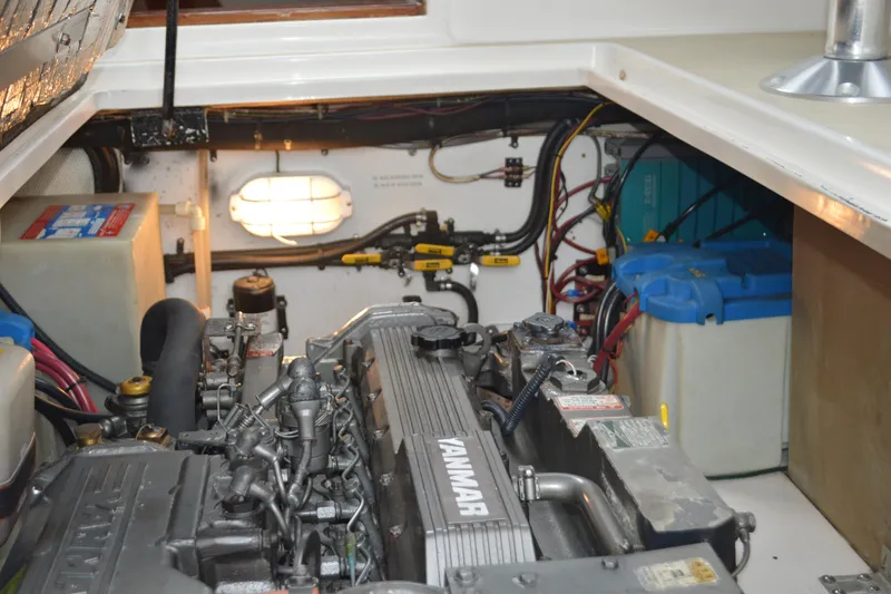 Slide: The Image of Engine room of a 2003 Legacy 28 Express boat with Yanmar engine and batteries. - 14