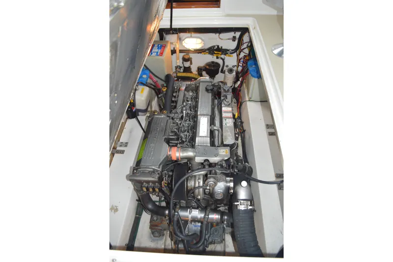 Slide: The Image of Engine compartment of a 2003 Legacy 28 Express boat, showcasing detailed mechanical components. - 13
