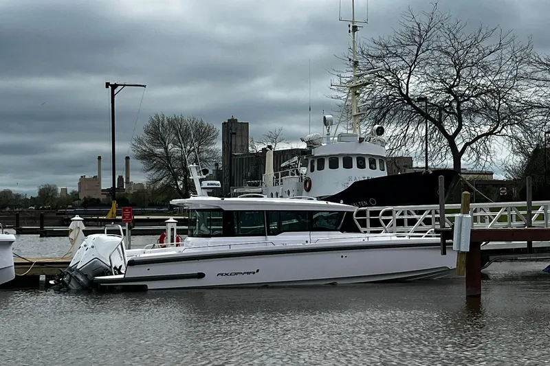 The Image of 2025 Axopar 37 XC Cross Cabin boat docked on a cloudy day. - 0
