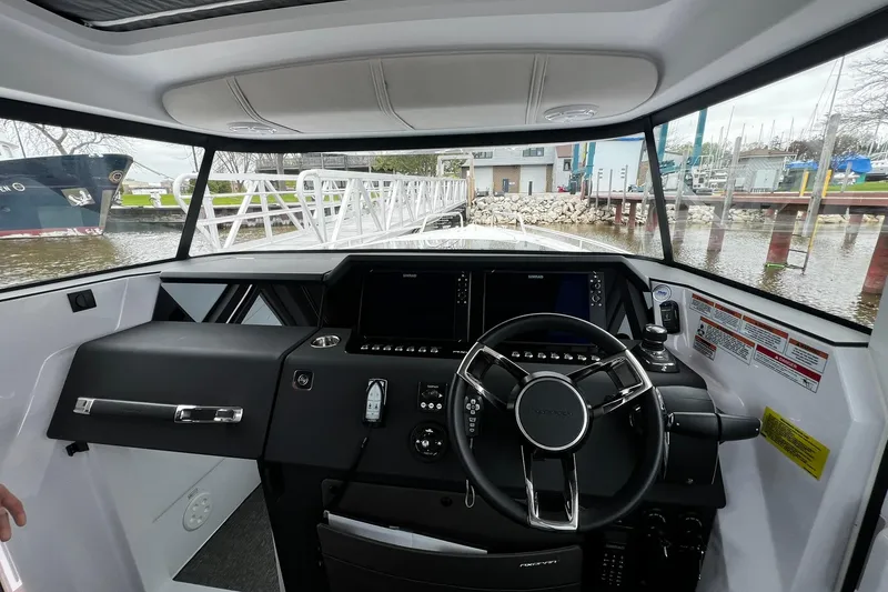 Slide: The Image of Interior view of 2025 Axopar 37 XC Cross Cabin helm with modern controls. - 10