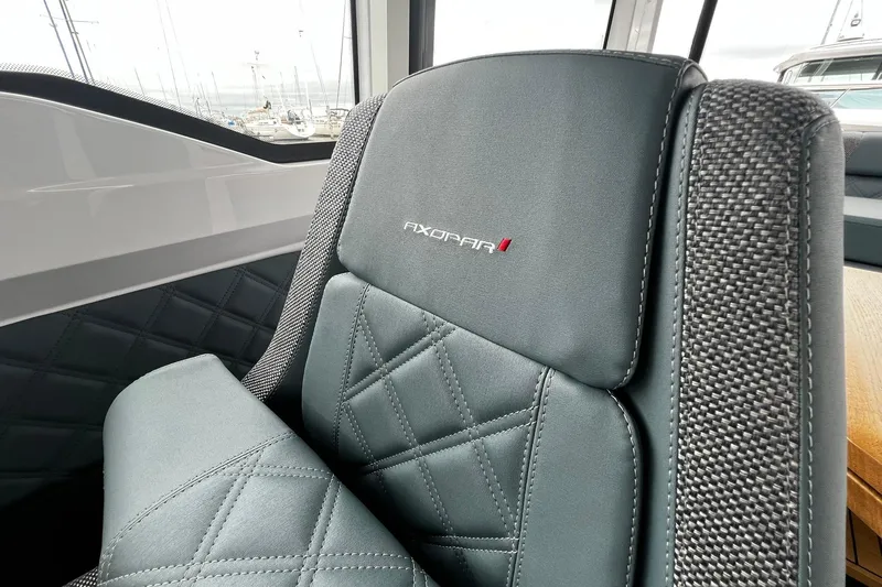Slide: The Image of Luxurious seating in the 2025 Axopar 37 XC Cross Cabin boat interior. - 13