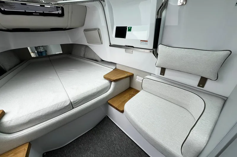 Slide: The Image of 2025 Axopar 37 XC Cross Cabin interior with modern seating and sleeping area. - 21