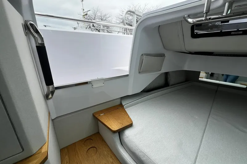 Slide: The Image of 2025 Axopar 37 XC Cross Cabin interior with sleek design and comfortable seating. - 23