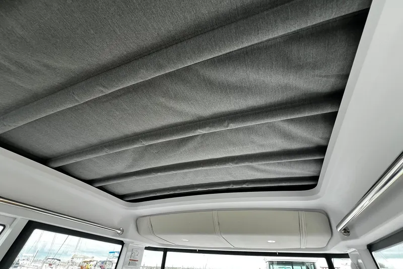 Slide: The Image of 2025 Axopar 37 XC Cross Cabin interior roof with sleek, modern design and fabric finish. - 24