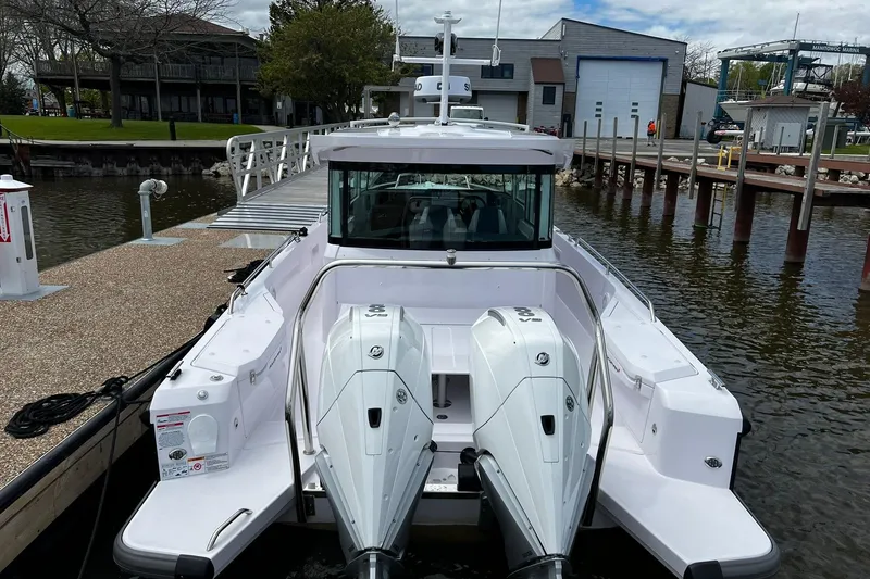 Slide: The Image of 2025 Axopar 37 XC Cross Cabin docked, showcasing dual outboard engines and sleek design. - 3