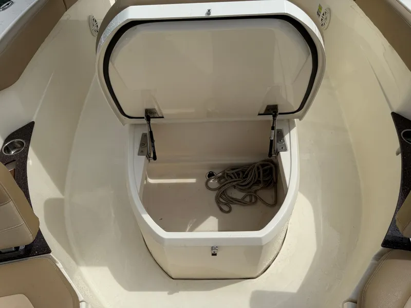 Slide: The Image of An open storage compartment on a Scout 235 XSF boat with rope inside. - 14