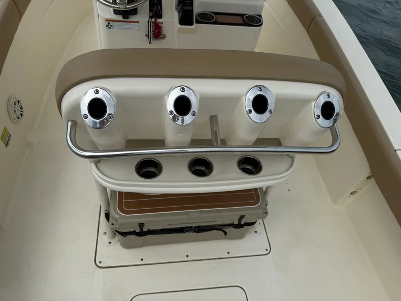 Slide: The Image of The image shows the back of a boat seat with four fishing rod holders. - 13