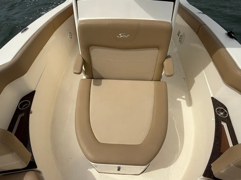 Slide: The Image of The image shows the seating area of a 2020 Scout 235 XSF boat with beige upholstery. - 9