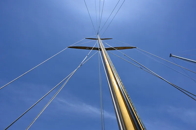 Slide: The Image of Looking up at the mast of a 1963 Rhodes 50 sailboat against a clear blue sky. - 31
