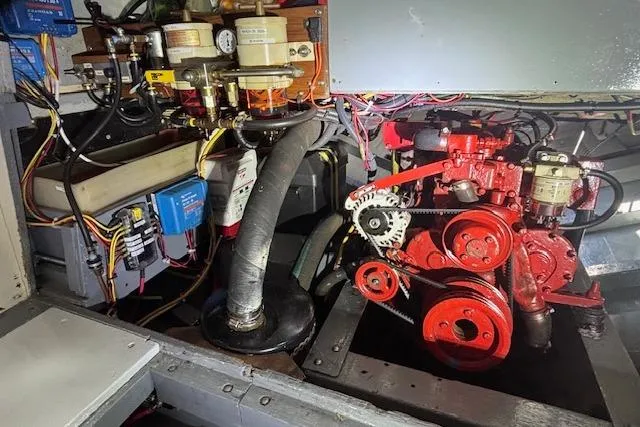 Slide: The Image of Engine room of a 1963 Rhodes 50, showcasing mechanical components and wiring. - 38