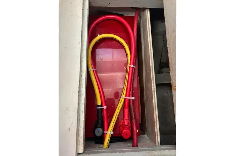 Slide: The Image of Red and yellow cables in a compartment of a 1963 Rhodes 50 Cutter. - 48
