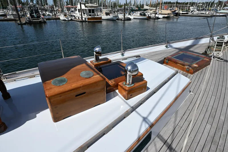 Slide: The Image of Deck of 1963 Rhodes 50 Cutter yacht with wooden details and marina view. - 21