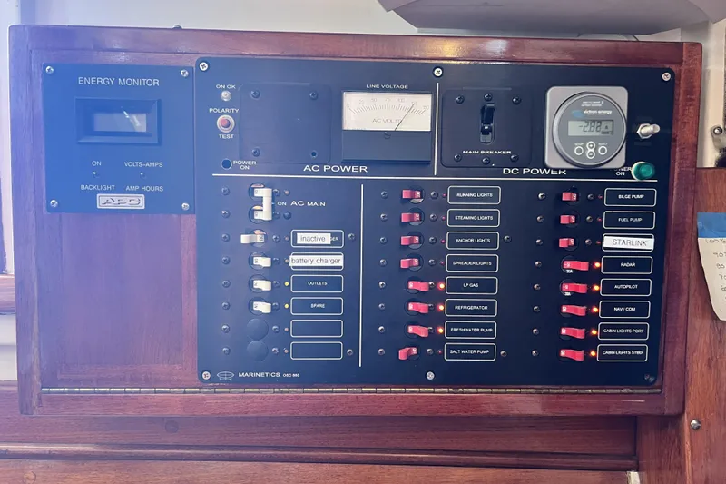 Slide: The Image of Electrical control panel on a 1963 Rhodes 50 Cutter sailboat, featuring AC and DC power switches. - 45
