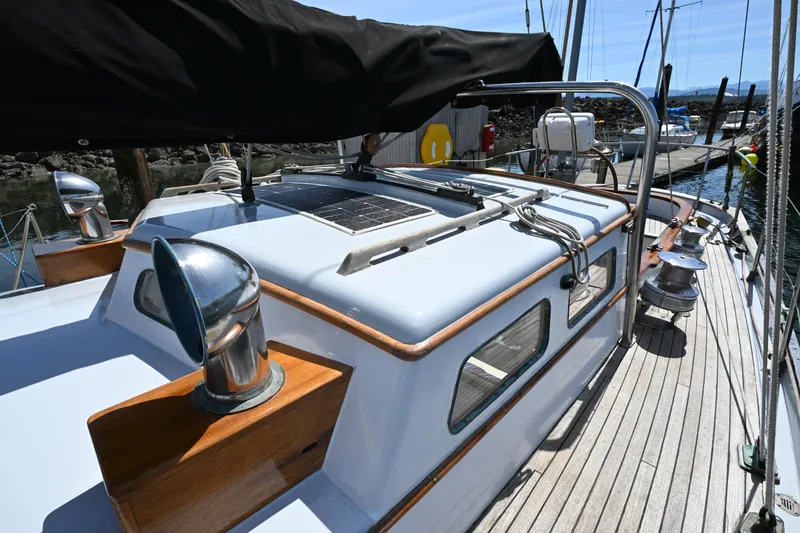 Slide: The Image of 1963 Rhodes 50 sailboat deck with polished metal fittings and wooden accents. - 20