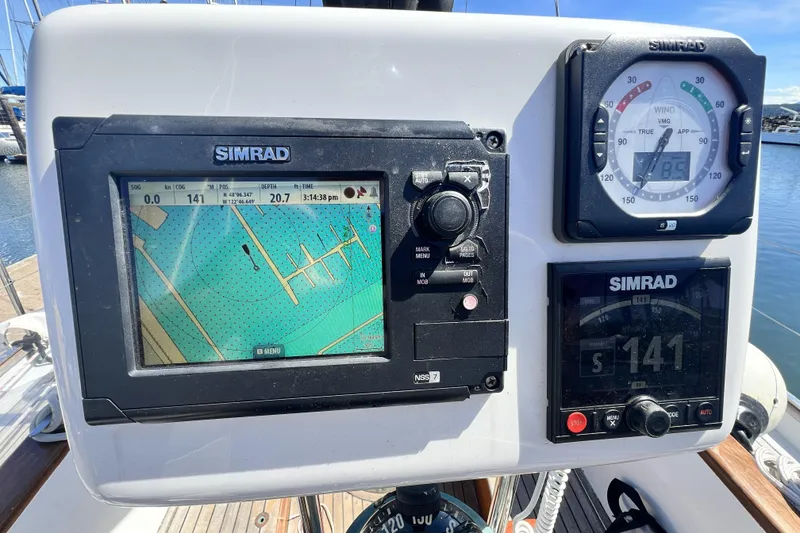 Slide: The Image of Navigation equipment on a 1963 Rhodes 50 sailboat, featuring Simrad displays and controls. - 9