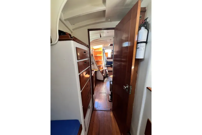 Slide: The Image of Interior of a 1963 Rhodes 50 sailboat with wooden cabinetry and flooring. - 26
