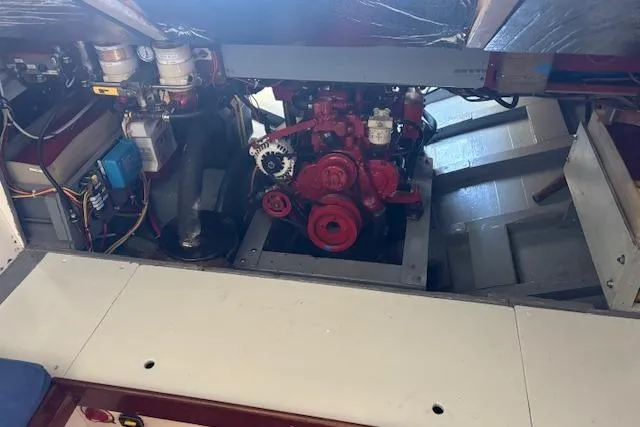 Slide: The Image of Engine compartment of a 1963 Rhodes 50 boat, showcasing mechanical components and wiring. - 40