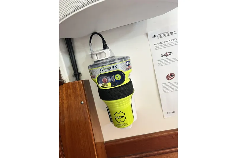 Slide: The Image of Emergency beacon mounted on a 1963 Rhodes 50 Cutter sailboat, with safety instructions nearby. - 49