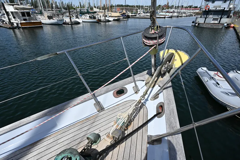 Slide: The Image of Bow of 1963 Rhodes 50 sailboat docked in marina with surrounding boats. - 15
