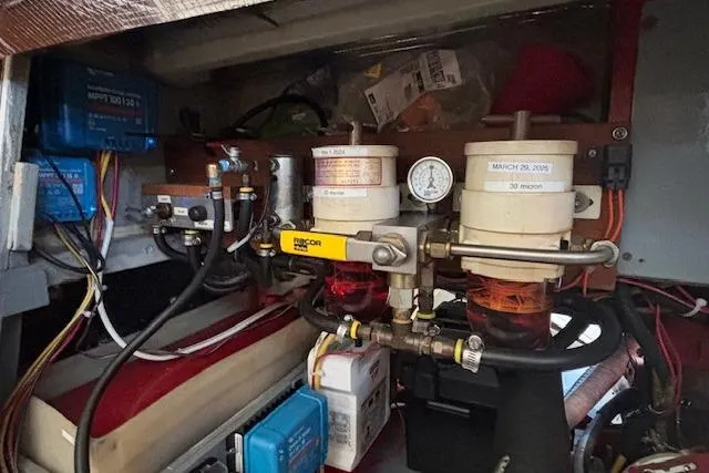 Slide: The Image of Engine compartment of a 1963 Rhodes 50, featuring fuel filters and electrical components. - 39