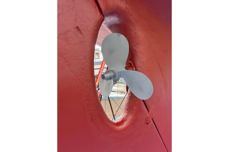 Slide: The Image of Propeller of 1963 Rhodes 50 Cutter sailboat, showcased in dry dock. - 50