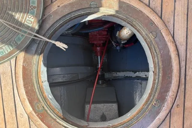 Slide: The Image of Circular hatch on 1963 Rhodes 50 boat deck, revealing interior mechanical components. - 43
