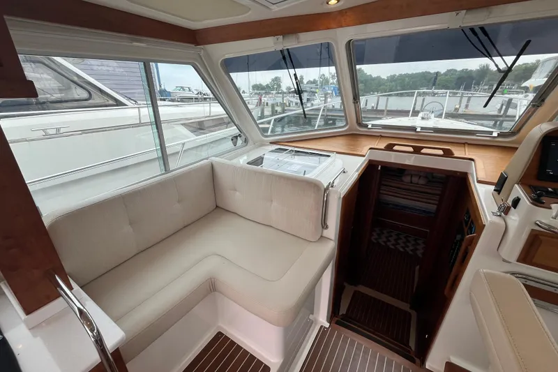 Slide: The Image of 2018 Back Cove 41 yacht interior with beige seating and wooden accents. - 9