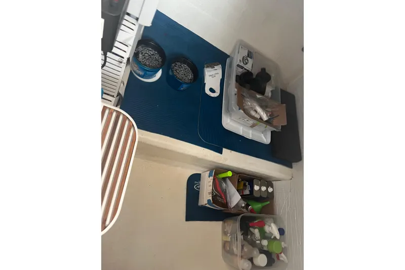 Slide: The Image of Storage area on a 2018 Back Cove 41 boat with organized supplies and containers. - 13