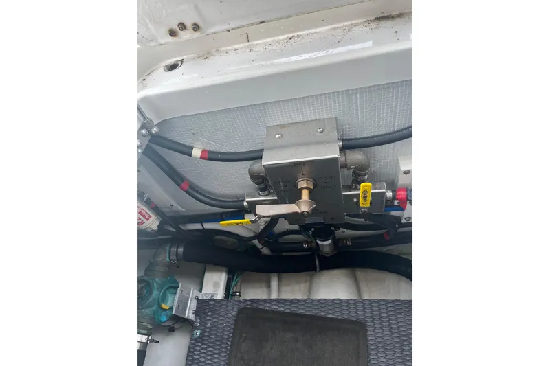 Slide: The Image of Engine compartment of a 2018 Back Cove 41 boat, showing mechanical components and hoses. - 23