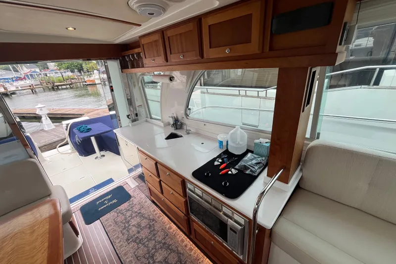 Slide: The Image of Interior of 2018 Back Cove 41 yacht with modern kitchen and dockside view. - 10
