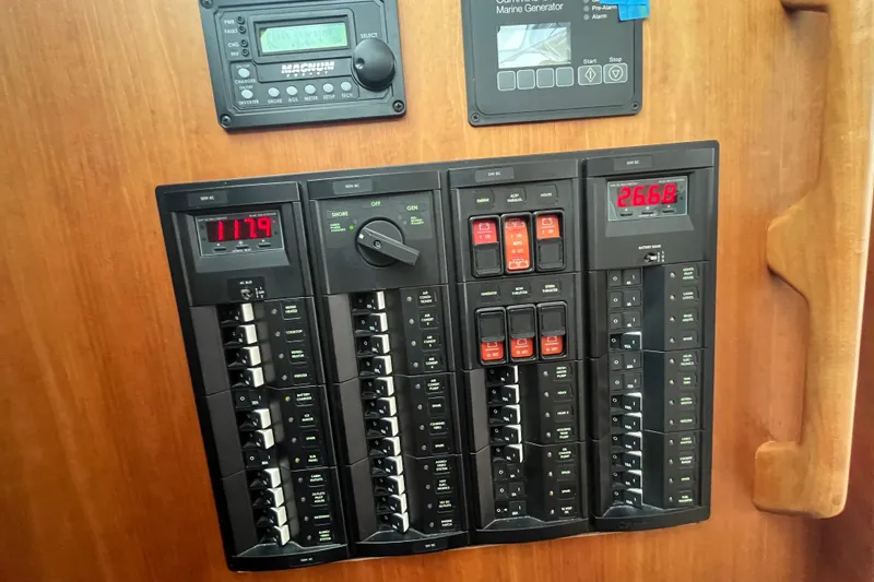 Slide: The Image of Electrical control panel on a 2018 Back Cove 41 boat, featuring various switches and displays. - 12