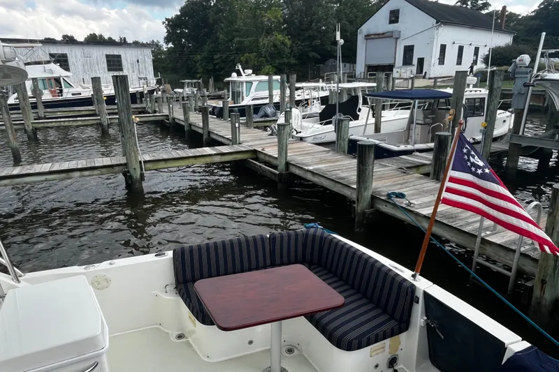 Slide: The Image of 2018 Back Cove 41 yacht docked at marina with American flag and seating area. - 6