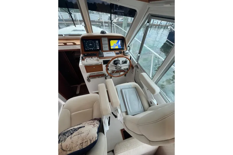 Slide: The Image of Helm of 2018 Back Cove 41 yacht with navigation screens and plush seating. - 11