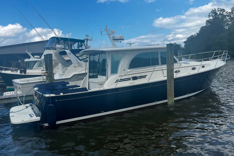 Slide: The Image of 2018 Back Cove 41 yacht docked at marina under blue sky. - 4