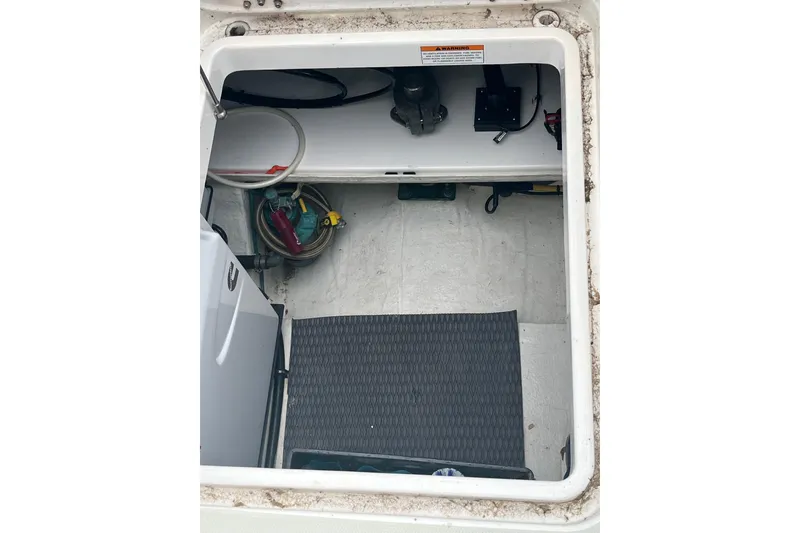 Slide: The Image of Storage compartment of a 2018 Back Cove 41 boat, featuring equipment and hoses. - 24