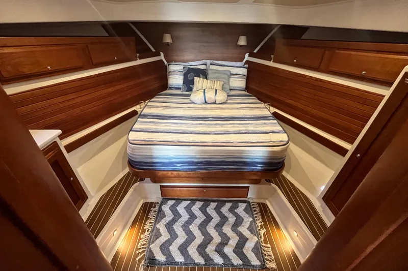 Slide: The Image of Luxurious cabin interior of 2018 Back Cove 41 yacht with striped bedding and wooden accents. - 17