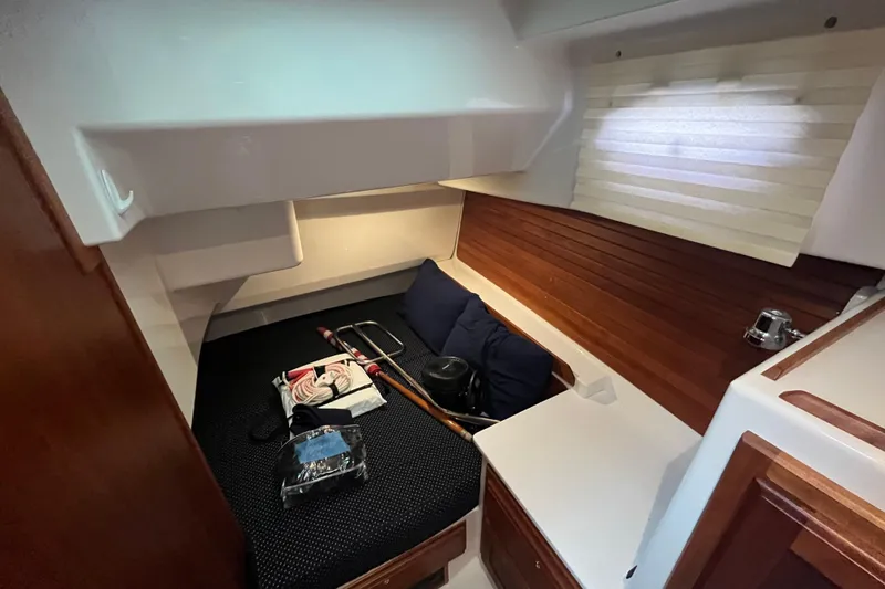 Slide: The Image of 2018 Back Cove 41 cabin interior with bed, wooden accents, and window blinds. - 14