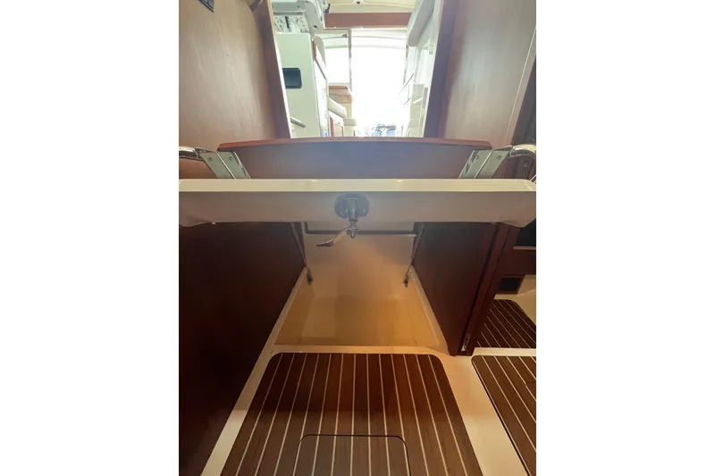 Slide: The Image of Interior view of 2018 Back Cove 41 yacht, featuring wooden flooring and cabinetry. - 16