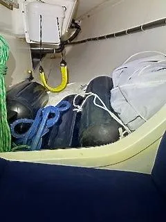 Slide: The Image of The image shows a boat's storage area with fenders, ropes, and sails. - 18