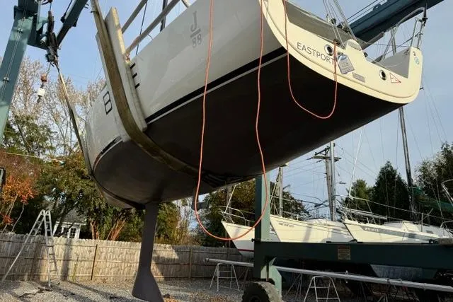 Slide: The Image of 2015 J Boats J/88 sailboat being lifted by a crane in a boatyard. - 5