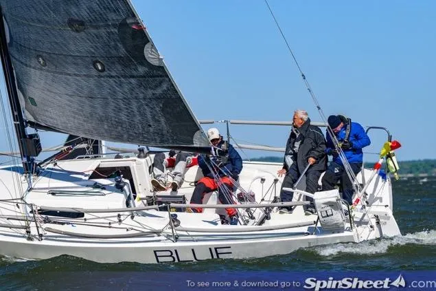 Slide: The Image of Sailing crew on 2015 J Boats J/88 yacht "BLUE" navigating through open waters. - 2