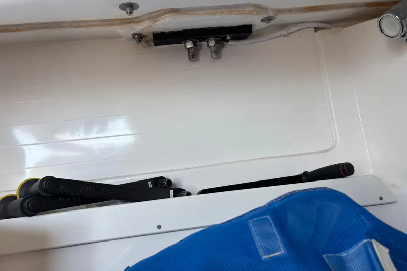 Slide: The Image of Interior view of a 2015 J Boats J/88 sailboat, featuring storage compartment and tools. - 28
