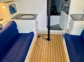 Slide: The Image of Interior of a 2015 J/88 with blue seating and wooden flooring. - 11