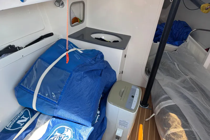 Slide: The Image of Interior of a 2015 J Boats J/88 sailboat with blue sail bags and equipment. - 23