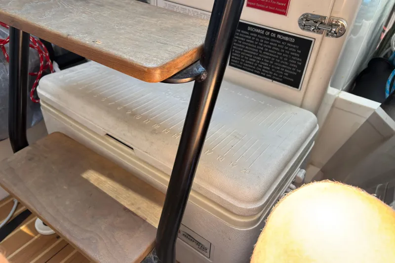 Slide: The Image of Interior of a 2015 J Boats J/88, featuring a wooden step and storage compartment. - 25