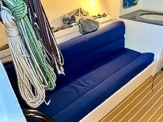Slide: The Image of Interior of the 2015 J/88 with a blue cushioned bench and ropes. - 12