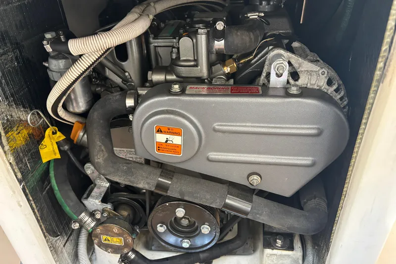 Slide: The Image of Engine compartment of a 2015 J Boats J/88 sailboat, showcasing mechanical components. - 26