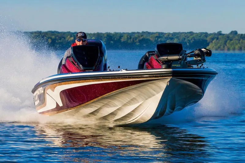 Slide: The Image of Manufacturer Provided Image: 2018 Nitro Z20 Pro boat speeding on a lake with a scenic forest backdrop. - 19