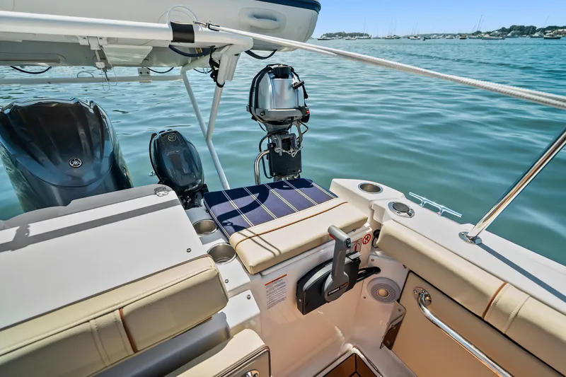 Slide: The Image of 2024 Ranger Tugs R-27 boat interior with Yamaha outboard motors on calm water. - 23